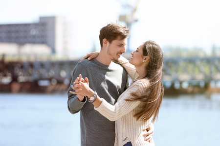 Happy young couple dancing outdoorsの写真素材