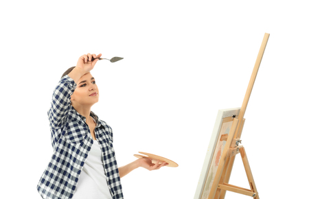 Tired female artist with drawing easel on white backgroundの写真素材