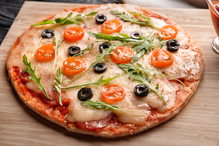 Tasty pizza on wooden boardの写真素材