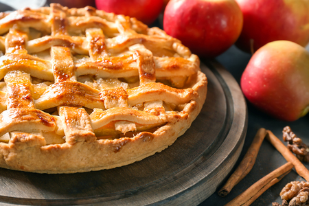 Tasty homemade apple pie on wooden boardの写真素材