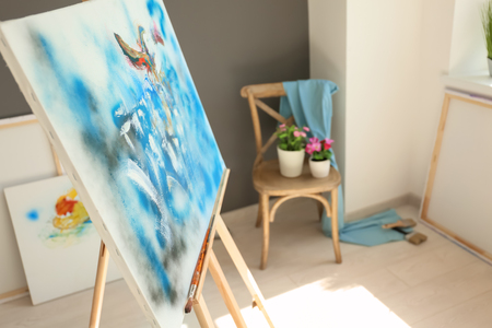 Drawing easel with picture in artist's workshopの写真素材