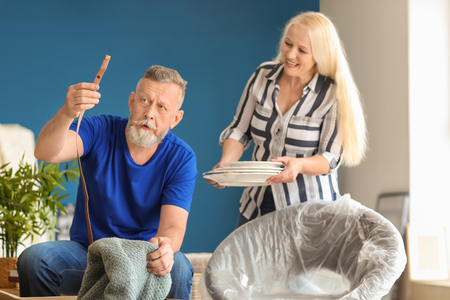 Mature couple unpacking belongings at new homeの写真素材