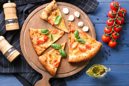 Composition with slices of delicious pizza Margherita on wooden backgroundの写真素材