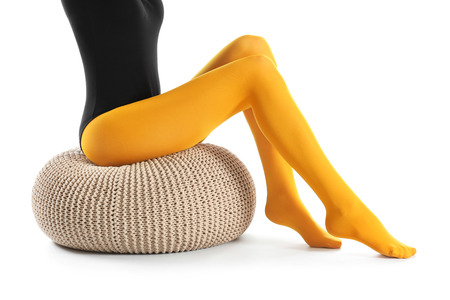 Legs of beautiful young woman in tights on white backgroundの写真素材