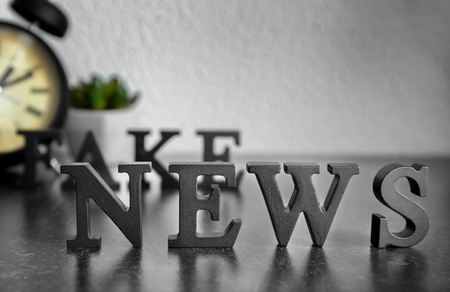 Words FAKE NEWS made of black letters on tableの写真素材