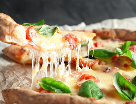 Taking slice of delicious pizza Margherita, closeupの写真素材