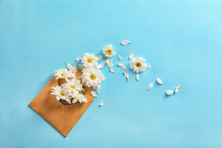 Open mail envelope with flowers on color backgroundの写真素材