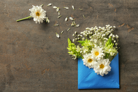 Open mail envelope with flowers on grey textured backgroundの写真素材