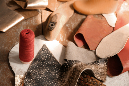 Leather with craft items on table in workshopの写真素材