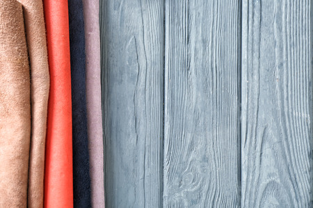 Colorful leather on wooden background
