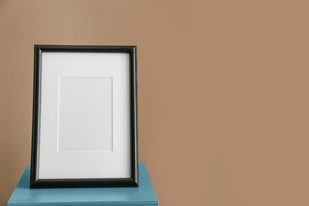 Photo frame on stand against color backgroundの写真素材