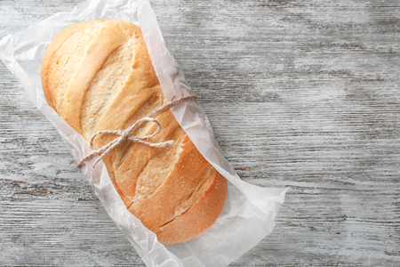 Fresh tasty bread on wooden backgroundの写真素材