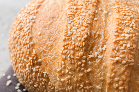 Fresh tasty bread with sesame seeds on table, closeupの写真素材