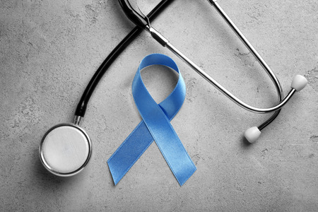 Blue ribbon and stethoscope on grey background. Prostate cancer conceptの写真素材