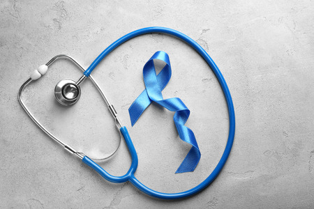 Blue ribbon and stethoscope on grey background. Prostate cancer conceptの写真素材