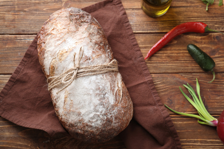 Fresh tasty bread on wooden backgroundの写真素材