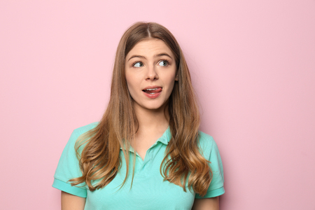Emotional young woman on color backgroundの写真素材