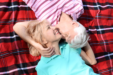Mature couple resting in park on spring dayの写真素材