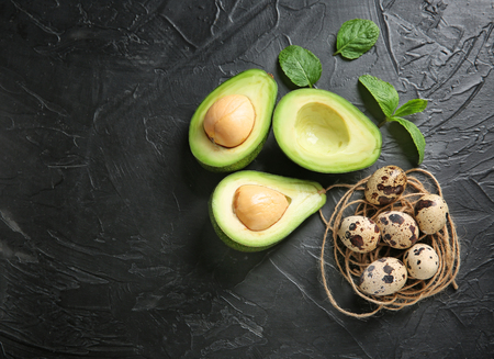 Avocado with ingredients for natural homemade cosmetics on dark backgroundの写真素材
