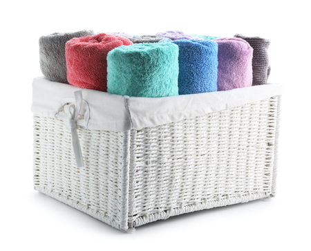 Wicker basket with towels on white backgroundの写真素材
