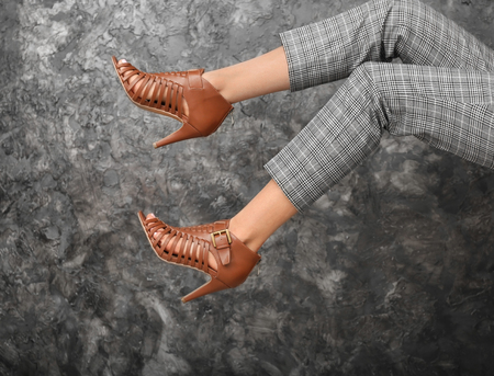 Legs of beautiful young woman on dark grey backgroundの写真素材