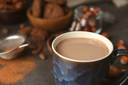 Cup with hot cocoa drink on tableの写真素材