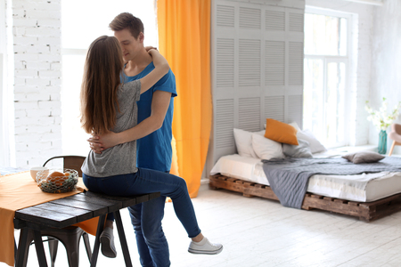 Happy young couple in love at homeの写真素材