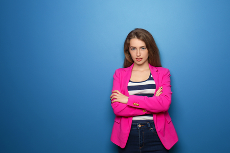 Portrait of beautiful young woman on color backgroundの写真素材