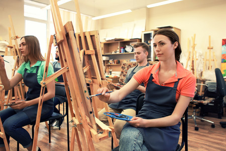Art students painting in workshopの写真素材