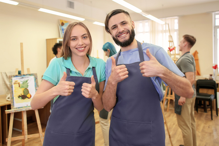 Students showing thumb-up gesture in art schoolの写真素材