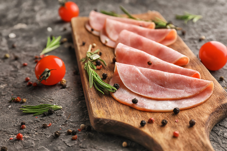 Board with delicious sliced ham on textured table, closeupの写真素材