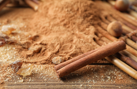 Cinnamon sticks, powder and sugar on wooden background, closeupの写真素材
