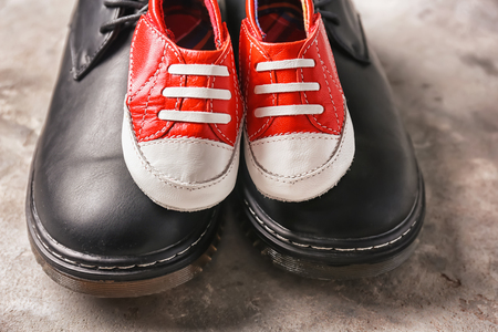 Big and small shoes on grey background. Father's day celebrationの写真素材