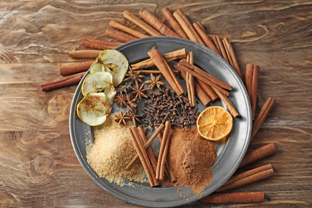 Composition with cinnamon sticks on wooden backgroundの写真素材