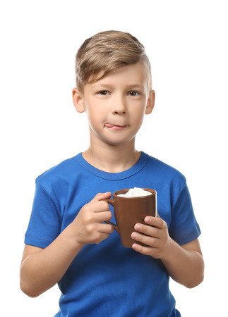 Cute little boy with cup of hot cocoa drink on white backgroundの写真素材