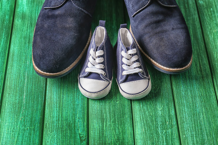 Big and small shoes on wooden background. Father's day celebrationの写真素材