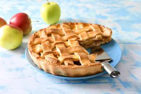 Plate with delicious apple pie on light backgroundの写真素材