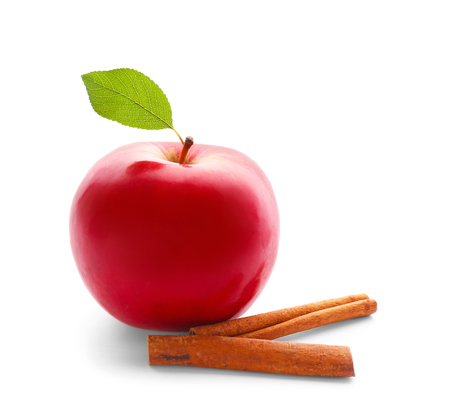 Fresh apple and cinnamon sticks on white backgroundの写真素材