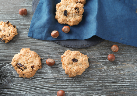 Delicious oatmeal cookies on wooden background
