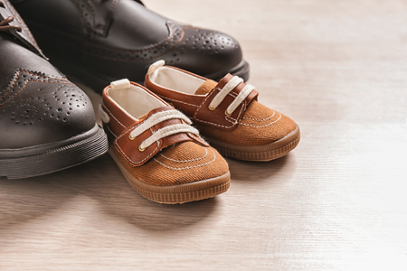 Big and small shoes on light background, closeup. Father's dayの写真素材