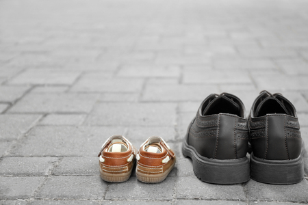 Big and small shoes on pavement outdoors. Father's dayの写真素材