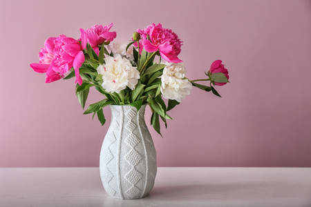Vase with beautiful flowers on tableの写真素材