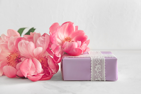 Beautiful peonies with gift box on light backgroundの写真素材