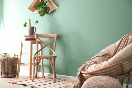 Stylish furniture near color wall in room interiorの写真素材