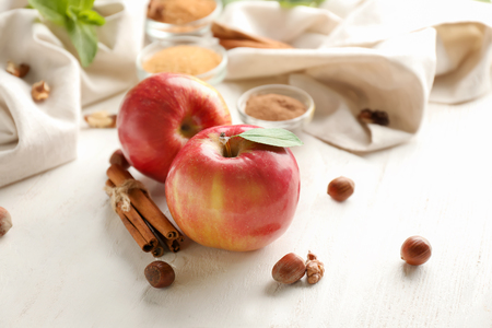 Fresh apples and cinnamon on wooden tableの写真素材