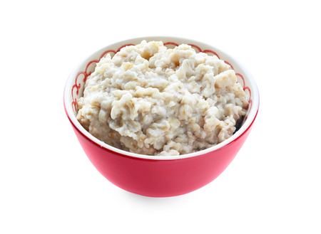 Tasty oatmeal in bowl on white backgroundの写真素材