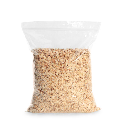 Package with raw oatmeal on white backgroundの写真素材