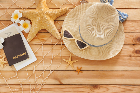 Composition with passport, ticket and beach items on wooden backgroundの写真素材