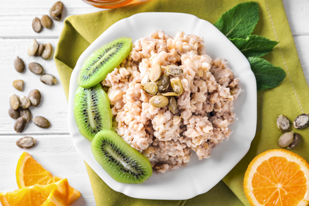 Composition with tasty oatmeal on white wooden tableの写真素材