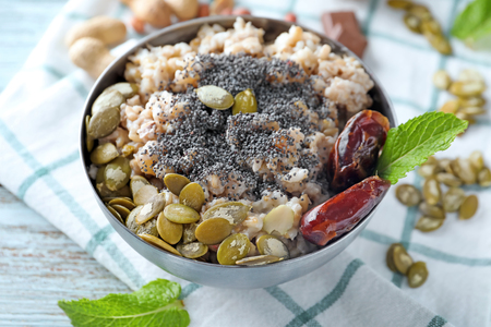 Bowl with tasty oatmeal on tableの写真素材
